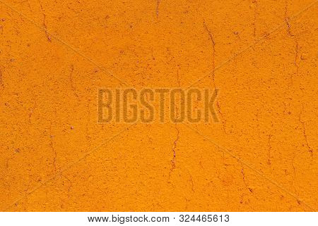 Bright Orange Cement Or Concrete Wall Texture Background. Old Painted Cracked Wall Close Up With Cop