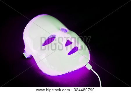Light Rejuvenating Mask For Facial Skin Therapy On Black Background