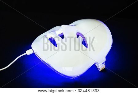Light Rejuvenating Mask For Facial Skin Therapy On Black Background
