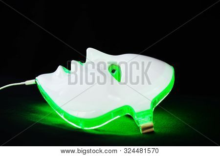 Light Rejuvenating Mask For Facial Skin Therapy On Black Background