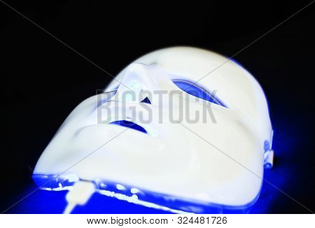 Light Rejuvenating Mask For Facial Skin Therapy On Black Background