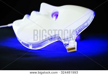 Light Rejuvenating Mask For Facial Skin Therapy On Black Background