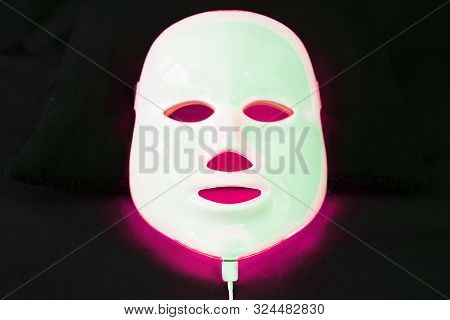 Light Rejuvenating Mask For Facial Skin Therapy On Black Background