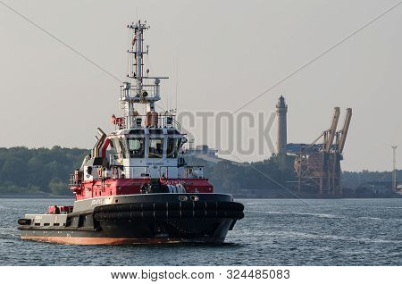 Swinoujscie, West Pomeranian / Poland - 2019: Fireboat Sails On The Background Of Sea Port