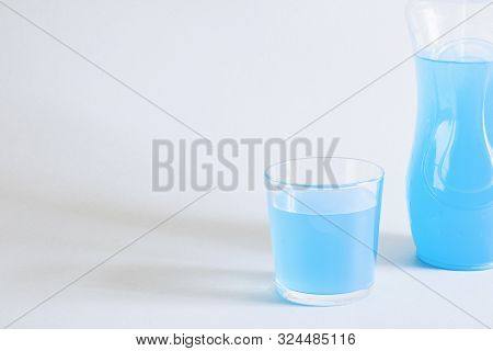 Isotonic Drink. Cold Blue Detox Cocktail In A Glass Cup Near A Sports Bottle. Beverage Concept For S