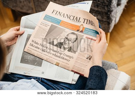 Paris, France - Sep 27, 2019: Woman Reading Financial Times In Living Room Newspaper Following The D