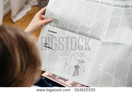 Paris, France - Sep 27, 2019: Woman Reading Le Figaro In Living Room Newspaper Following The Death O