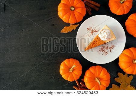 Slice Of Pumpkin Cheesecake With Whipped Cream. Top View, Side Border Over A Black Stone Background.