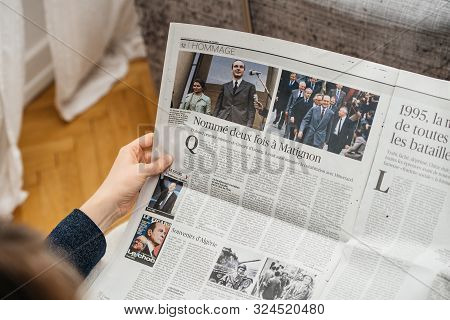 Paris, France - Sep 27, 2019: Woman Reading Le Figaro In Living Room Newspaper Following The Death O