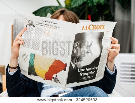 Paris, France - Sep 27, 2019: Woman Reading La Croix In Living Room Newspaper Following The Death Of