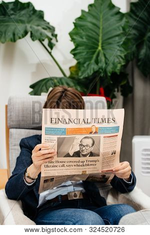 Paris, France - Sep 27, 2019: Woman Reading Financial In Living Room Newspaper Following The Death O