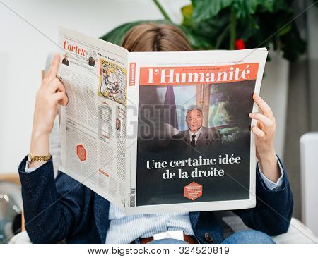 Paris, France - Sep 27, 2019: Woman Reading Lhumanite In Living Room Newspaper Following The Death O