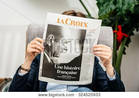 Paris, France - Sep 27, 2019: Woman Reading La Croix N Living Room Newspaper Following The Death Of 