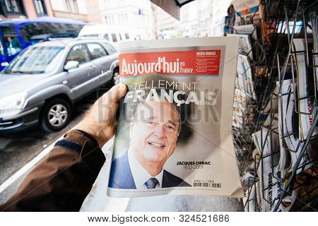Paris, France - Sep 27, 2019: Man Buying French Aujordhui With Jacques Chirac On Cover Of Newspaper 