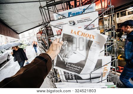 Paris, France - Sep 27, 2019: Man Buying French La Croix From Stand With Jacques Chirac On Cover Of 