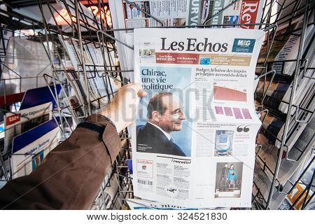 Paris, France - Sep 27, 2019: Man Buying French Le Echos From Stand With Jacques Chirac On Cover Of 