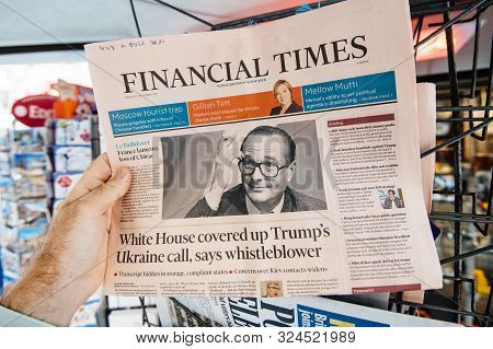 Paris, France - Sep 27, 2019: Man Buys Financial Times With Jacques Chirac On Cover Of Newspaper Fol