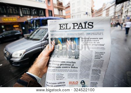 Paris, France - Sep 27, 2019: Man Reading Newspaper In Press Kiosk Featuring El Pais Spanish Cover W