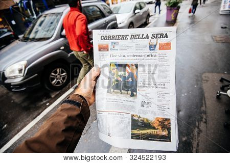 Paris, France - Sep 27, 2019: Man Reading Newspaper In Press Kiosk Featuring Corriere Della Sera Cov