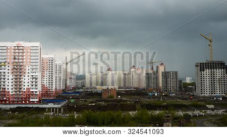 Novokuznetsk, Russia - 05.24.2019. The Process Of Building New High-rise Buildings, Tower Cranes And