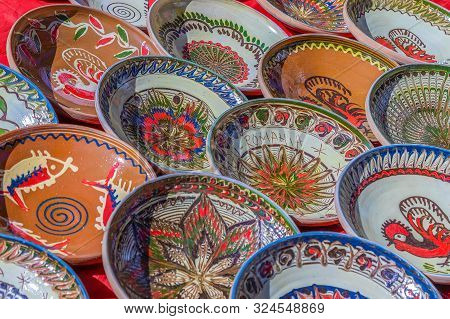 Background With Romanian Traditional Ceramic In The Plates Form, Painted With Specific Patterns From
