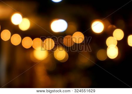 Abstract Blurred And Bokeh Light Bubs Reflection Lighting Of Small Pub In The City At The Night Time