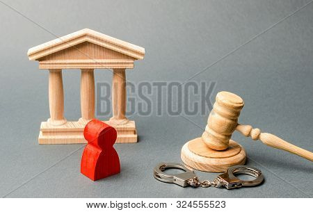 Red Figurine Of A Man At The Trial. Protection Of The Defendant In The Criminal Case. Protection Str