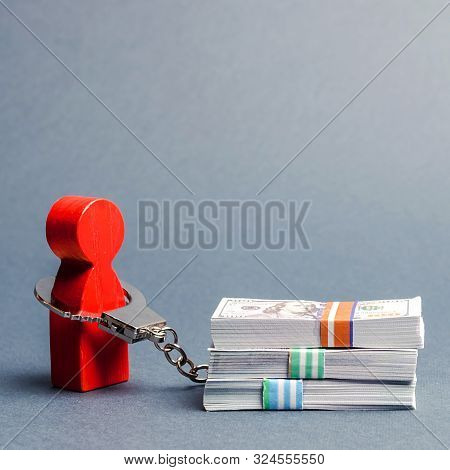 A Person Is Handcuffed With A Stack Of Money. Man Is Addicted To Money, Shopaholic. Money Can Not Bu