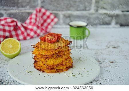 Hash Browns Or Potato Pancakes Or Swiss Rösti Garnish With Cherry Tomato And Parsley