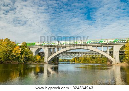 Kouvola, Finland - 25 September, 2019: Autumn Landscape Of Bridge With Moving Passenger Train And Ky