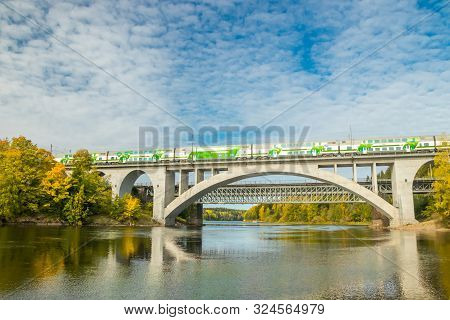 Kouvola, Finland - 25 September, 2019: Autumn Landscape Of Bridge With Moving Passenger Train And Ky