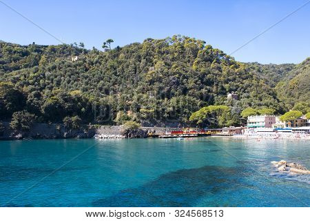 The Sand Beach Known As Paraggi Near Portofino In Genoa On A Blue Sky And Sea Background