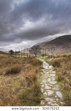 Beautiful Winter Landscape Image Looking Along Valley From Crimpiau Towards Mount Snowdon In The Dis