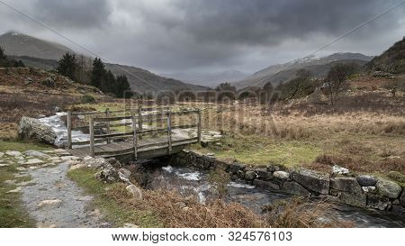 Beautiful Winter Landscape Image Looking Along Valley From Crimpiau Towards Mount Snowdon In The Dis