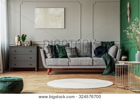Stylish Emerald Green And Grey Living Room Interior Design With Abstract Painting On The Wall