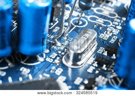 Macro Shot Of A Circuitboard With Resistors Microchips And Electronic Components. Computer Hardware