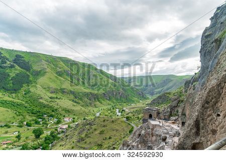 Panoramic View Of Vardzia Cave Monastery Town. View From The Monastery To The River Valley And Green
