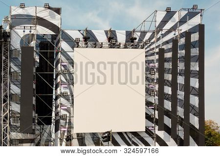 Huge Display And Loudspeakers On Metal Frame Construction Under Blue Sky. Mockup Of Screen Or Inform