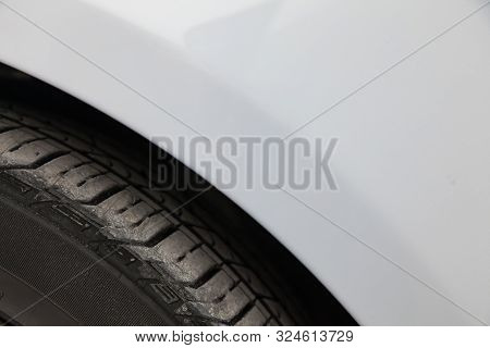 Background Of The Automotive Part Near The Wheel With A View Of The Tread And Tire Of The Vehicle.