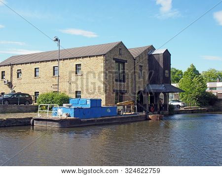 A View Of Buildings Around The Brighouse Basin With Moored Boat On The Calder And Hebble Navigation 