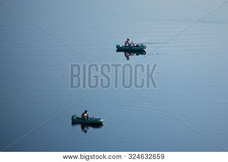 Moletai, Lithuania - September 1, 2018: Fishermen In Their Boats In Baltieji Lakajai Lake As Seen Fr