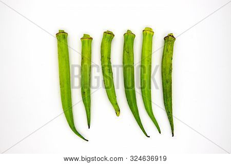 Green Bamia In Row On White Background. Tropical Vegetable Top View Photo. Exotic Plant With Edible 