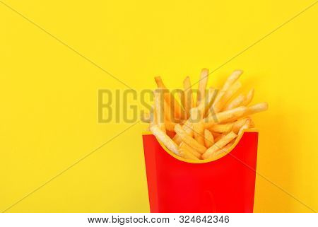 Frybox With French Fries On A Yellow Background, Copy Space