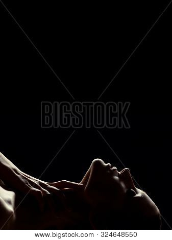 Young Topless Sensual Woman With Closed Eyes Lying On Black Background With Copy Space, Hand On Neck