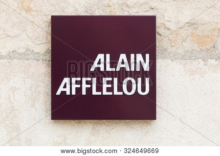 Villefranche, France - September 22, 2019: Alain Afflelou logo on a wall. Alain Afflelou is a French company, chain of opticians specialized in the distribution of frames and optical glasses