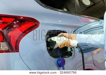 Close-up Asia Women Hands Who Are Fueling A New Vehicle Electrification Via Rechargeable Electricity