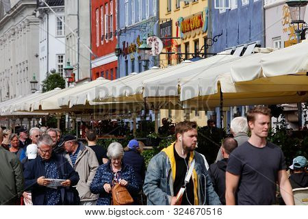Copenhagen, Denmark - September 4, 2019: People Valking The Nyhavn Street With Restaurants With Outd