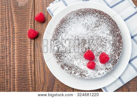 Chocolate Sticky Brownie Cake, Swedish Dessert Kladdkaka, On The Plate, Garnished With Icing Sugar A