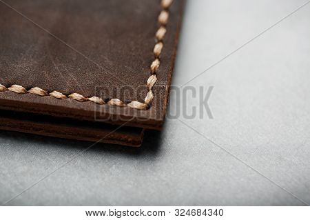 Wallet Keymaster Made Of Brown Genuine Leather, Handmade On A Dark Background