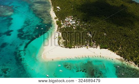 Sandy Beach With Tourists, Palm Trees And Turquoise Water On The Island Of Daco, Philippines, Aerial